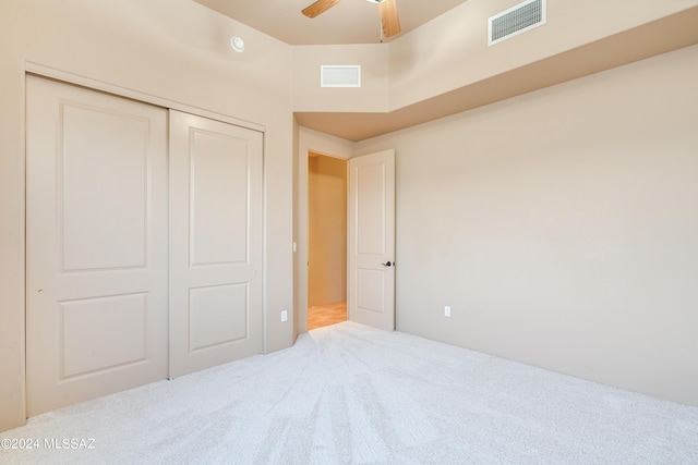 bedroom featuring ceiling fan, light colored carpet, and a closet