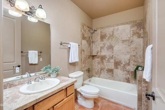 full bathroom featuring vanity, toilet, tiled shower / bath, and tile patterned flooring