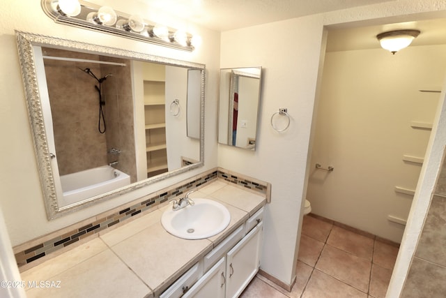 full bathroom with tiled shower / bath combo, vanity, tasteful backsplash, tile patterned floors, and toilet