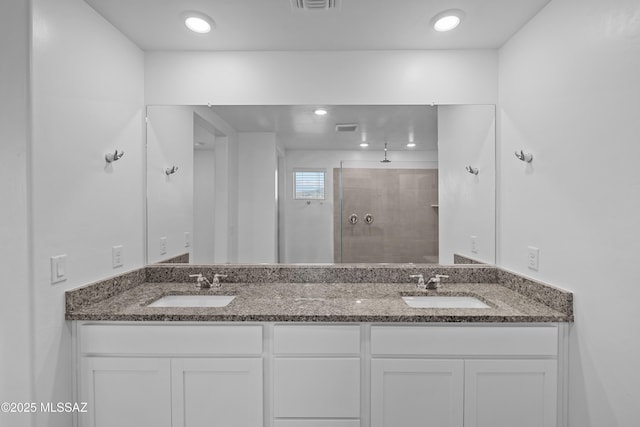 bathroom featuring vanity and a shower with door