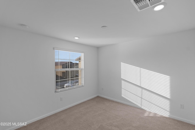 unfurnished room with light colored carpet