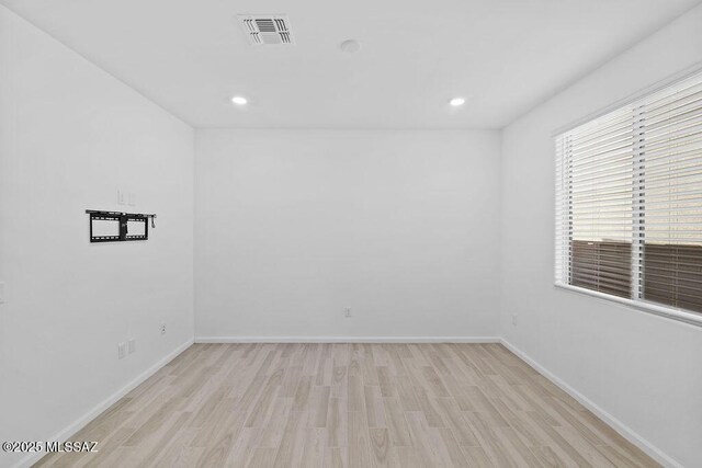 spare room featuring light hardwood / wood-style flooring