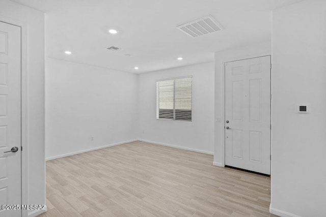 spare room featuring light hardwood / wood-style flooring