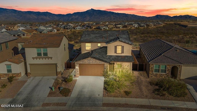 view of front of home with a mountain view and a garage