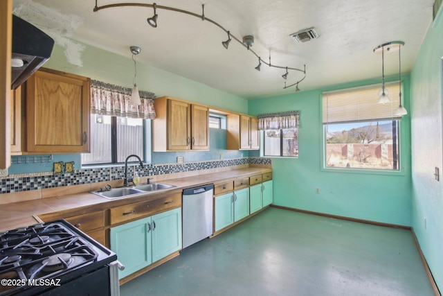 kitchen with pendant lighting, range with gas stovetop, dishwasher, sink, and backsplash