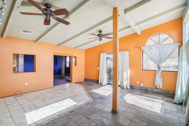 empty room with lofted ceiling with beams