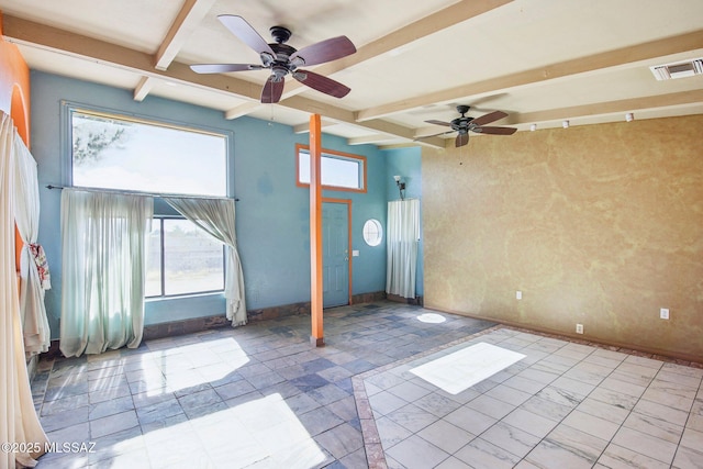 spare room with beamed ceiling and a high ceiling