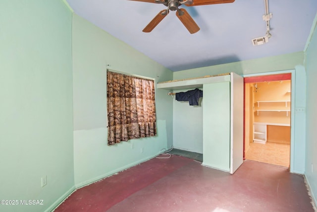 unfurnished bedroom featuring concrete floors, ceiling fan, and a closet