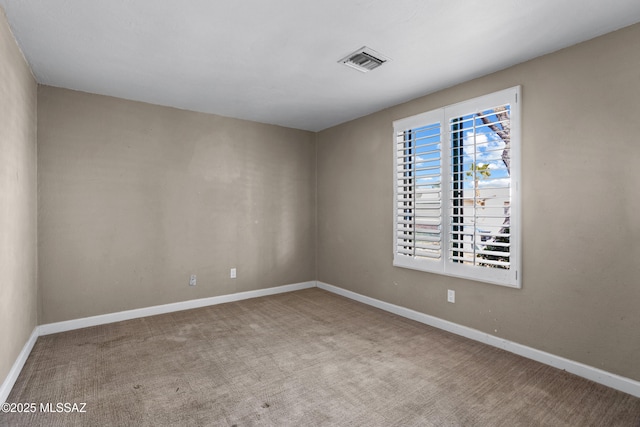 carpeted empty room with visible vents and baseboards