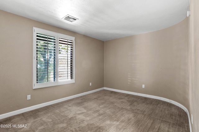 empty room with baseboards and visible vents