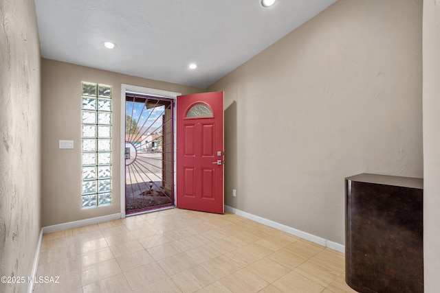 entrance foyer with recessed lighting, lofted ceiling, and baseboards