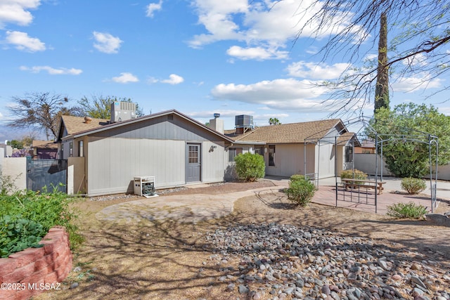 back of house with central AC, a patio, and fence