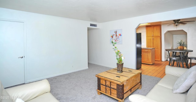 living room with light carpet and ceiling fan