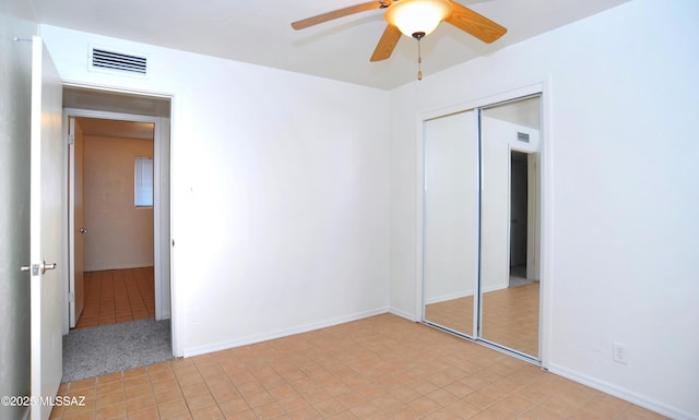 unfurnished bedroom featuring ceiling fan, a closet, and light tile patterned floors