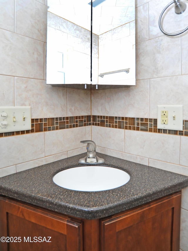 bathroom with tasteful backsplash and vanity