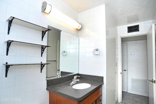 bathroom with tile walls and vanity