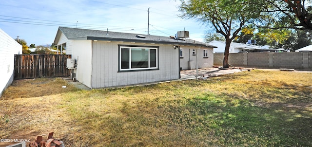 rear view of house with a lawn