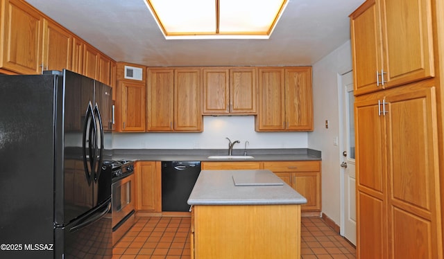 kitchen featuring tile patterned flooring, sink, a kitchen island, and black appliances