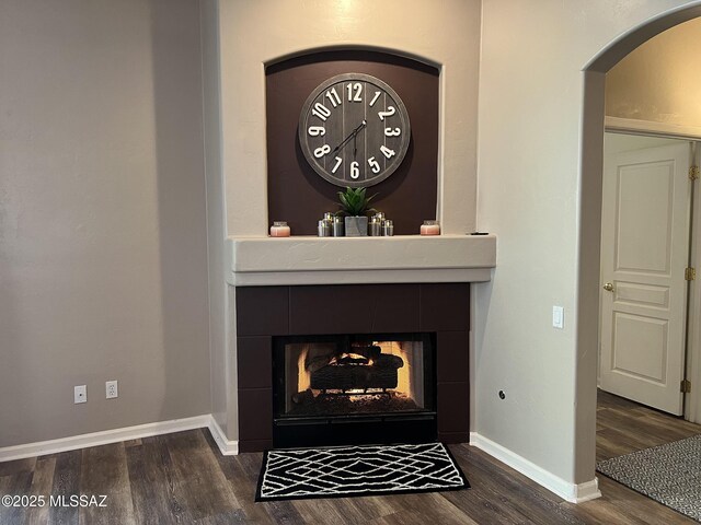 living room with ceiling fan and dark hardwood / wood-style flooring