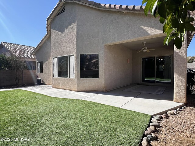 rear view of house featuring a lawn, a patio, and ceiling fan