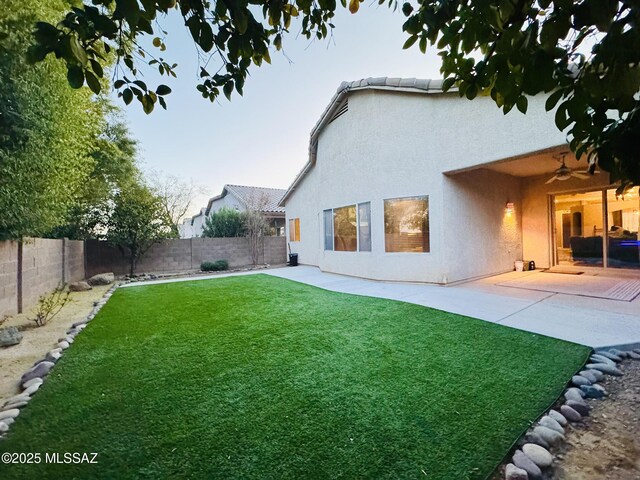 view of yard featuring a patio and ceiling fan