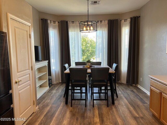 living room featuring dark hardwood / wood-style floors and a notable chandelier