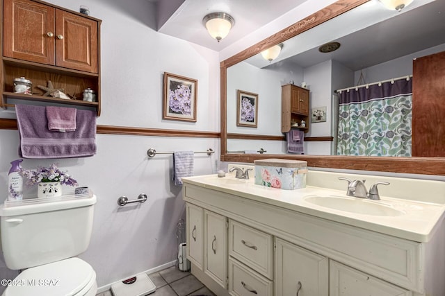 bathroom featuring vanity, tile patterned floors, toilet, and walk in shower