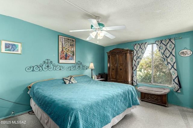 carpeted bedroom with ceiling fan and a textured ceiling