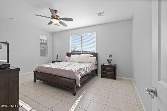 tiled bedroom featuring ceiling fan