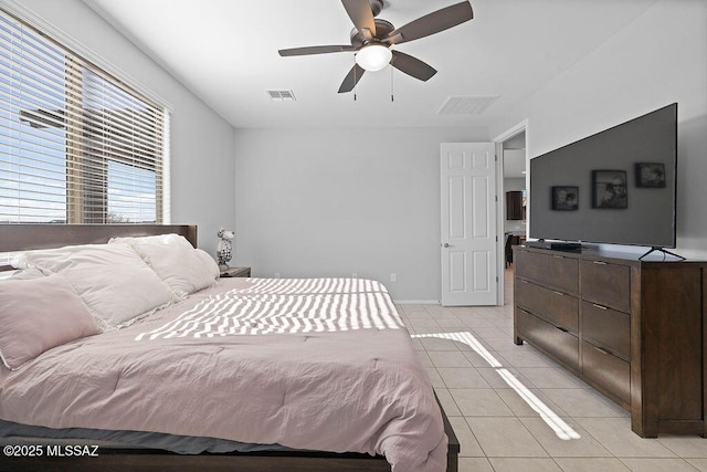 bedroom with ceiling fan and light tile patterned floors