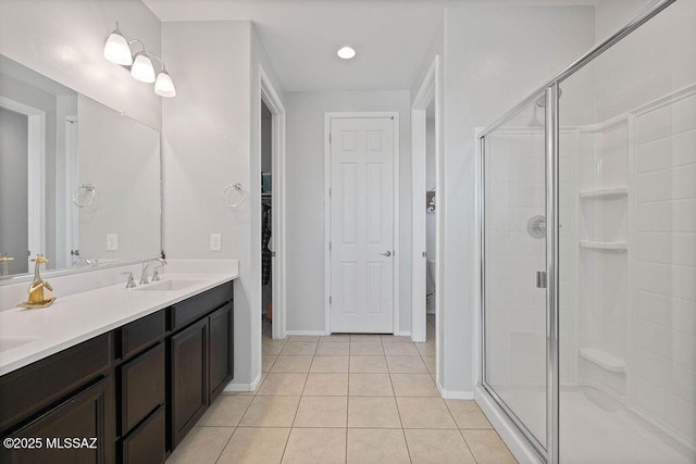 bathroom featuring vanity, tile patterned floors, and walk in shower