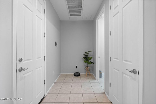 laundry area with light tile patterned floors