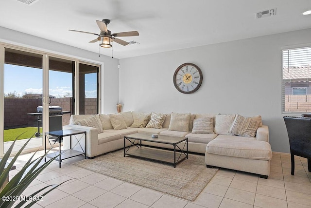 living room featuring light tile patterned floors and ceiling fan