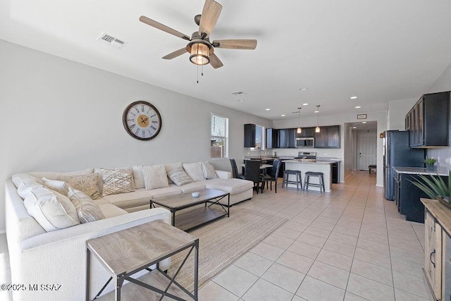 tiled living room featuring ceiling fan