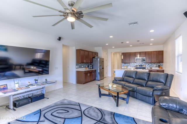 tiled living room featuring ceiling fan