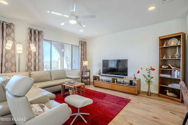 living room featuring ceiling fan and light wood-type flooring