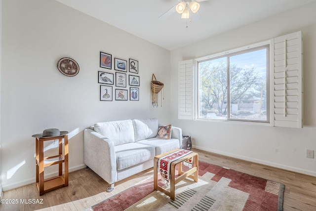 living room featuring hardwood / wood-style floors and ceiling fan