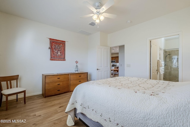 bedroom featuring ceiling fan, ensuite bath, and light hardwood / wood-style flooring