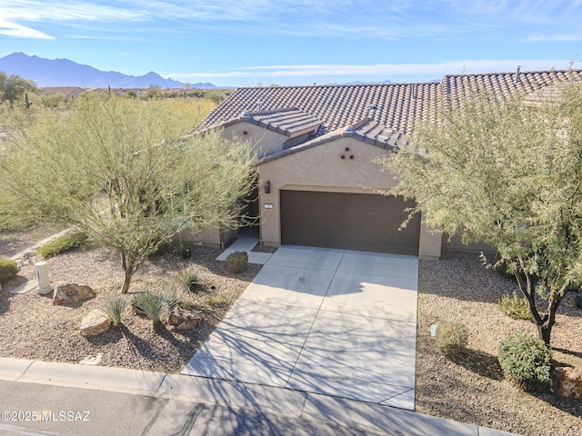 view of front of property with a garage and a mountain view