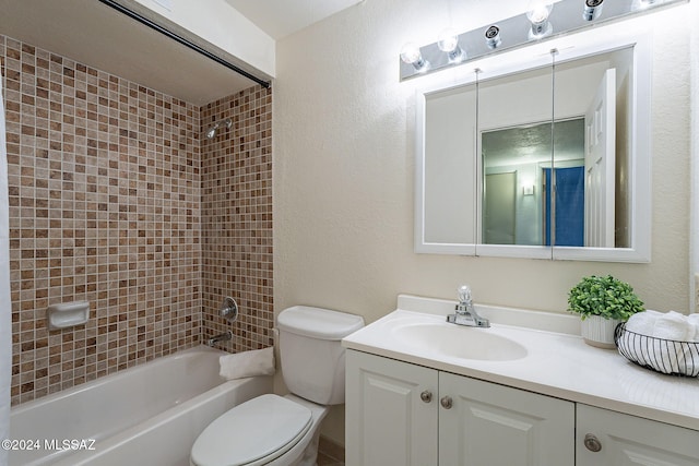 full bath featuring bathtub / shower combination, a textured wall, toilet, and vanity