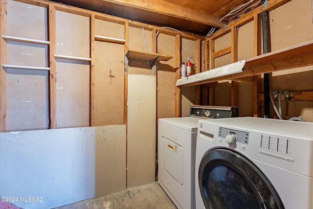 washroom featuring washer and clothes dryer and laundry area