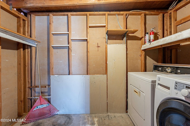 washroom with washing machine and clothes dryer and laundry area