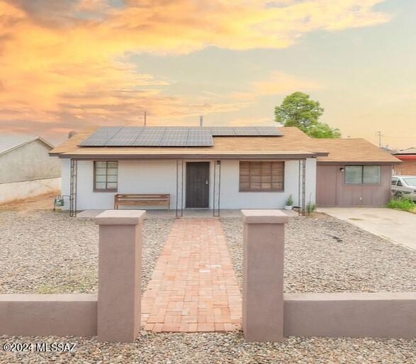 view of front facade with solar panels