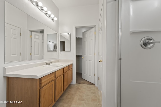 bathroom with vanity and a shower