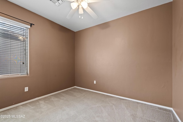 carpeted empty room featuring ceiling fan