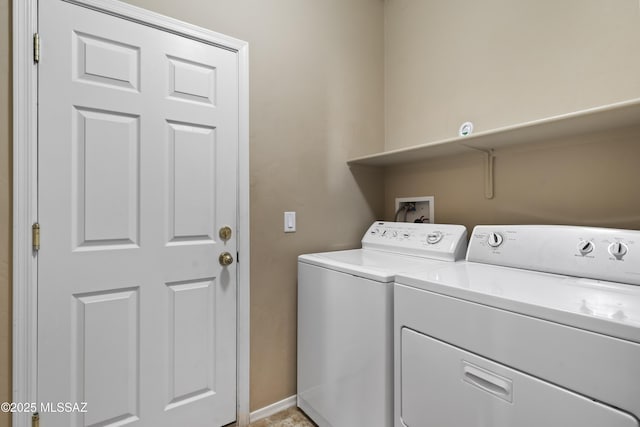 clothes washing area with washer and dryer