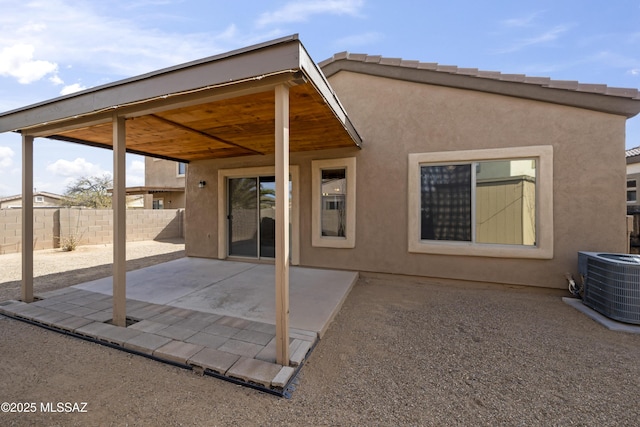 rear view of property featuring a patio area and central air condition unit