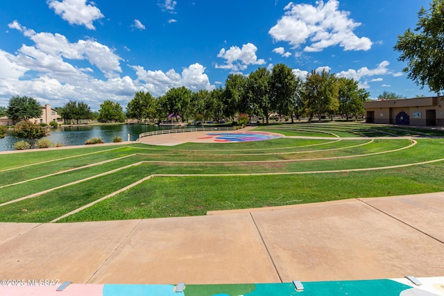 view of community with a yard and a water view