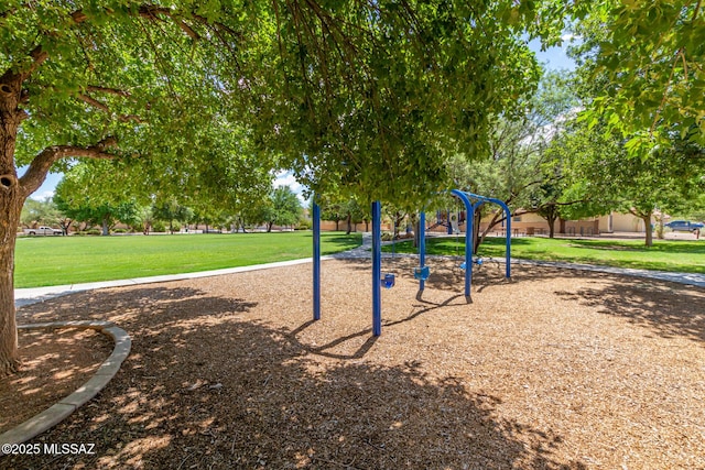 view of home's community featuring a playground and a lawn