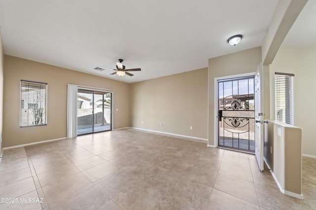 spare room featuring ceiling fan and light tile patterned floors